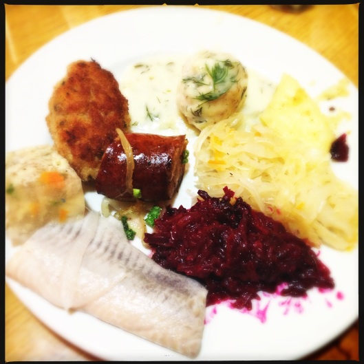 Schnitzel, Dill gravy meatballs, Fried Sauerkraut, Fried Beets, Herring in vinegar, Chicken Aspic and Polish Sausage (also a cheese dumpling which is hiding from the camera)